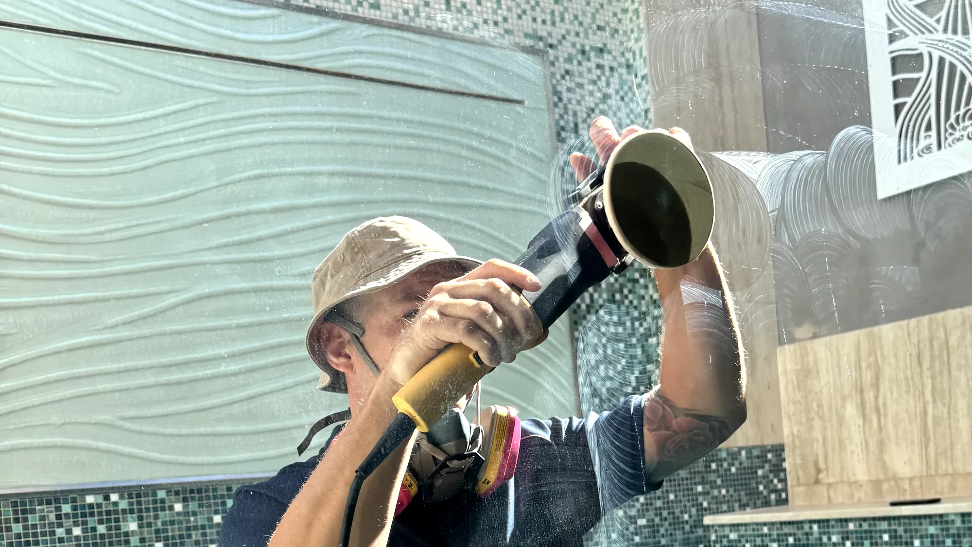 Extera specialist cutting damage out of a glass panel, dust thrown clear of the pad