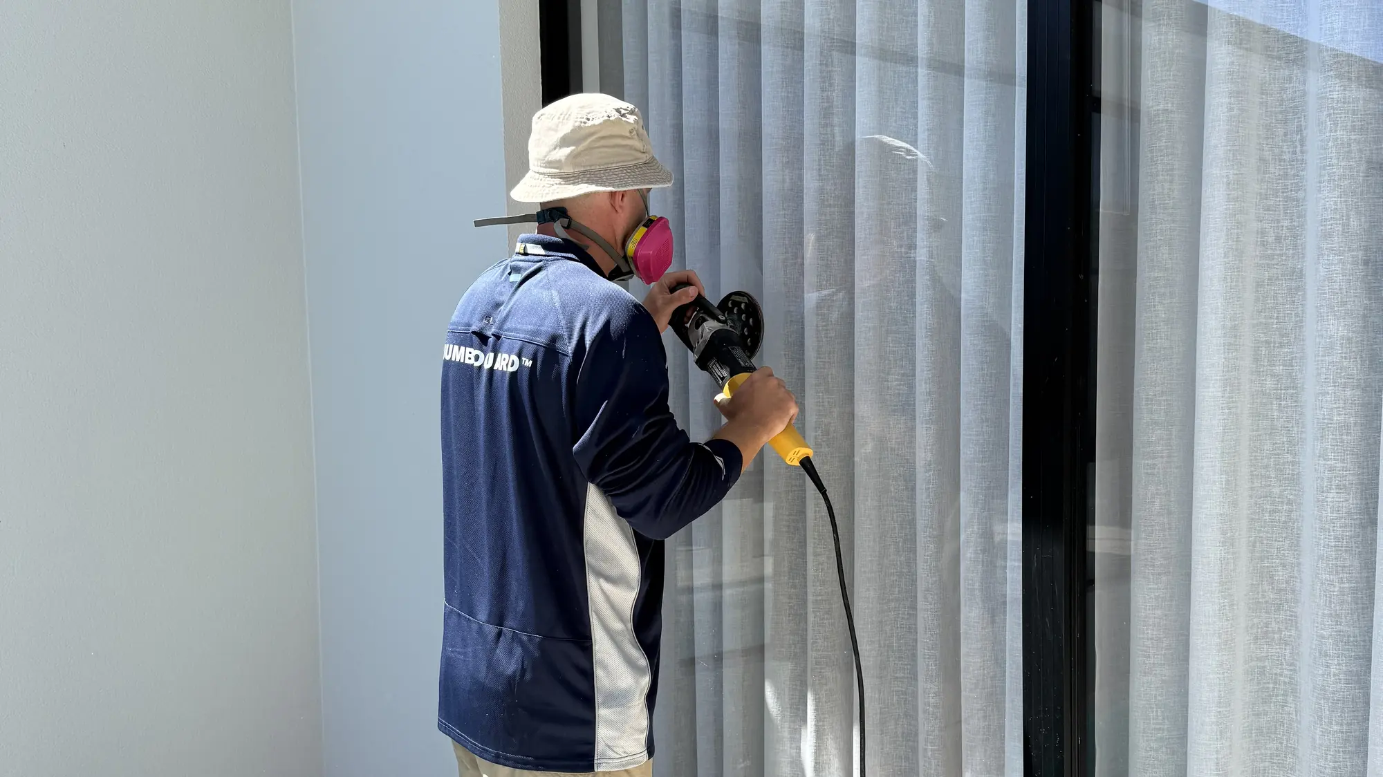 Extera specialist removing scratching from a large residential window pane