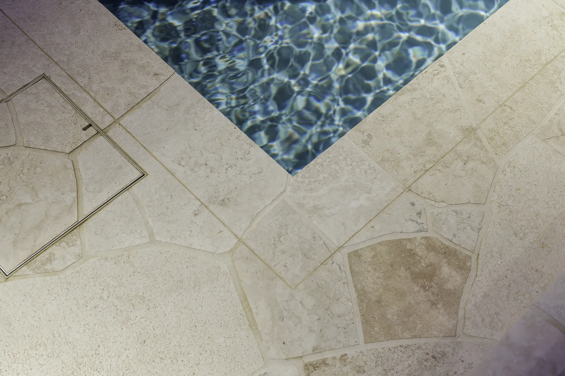 Sealed travertine pool coping